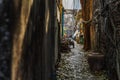 View along dark narrow street in the old village