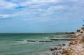 View along eroded beach with sand fencing in Progreso Mexico toward the worlds longest pier that allows ships to dock in the shall Royalty Free Stock Photo