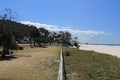 View along a fence rail between the shore and the beach Royalty Free Stock Photo