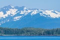 A view along the forested shoreline of the Gastineau Channel approaching Juneau, Alaska