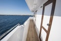 View along gangway of a large private motor yacht out at sea Royalty Free Stock Photo