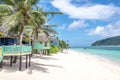 View along Lalomanu Beach, Upolu Island, Samoa, of colorful Samoan beach fale huts that are an alternative to hotel or resort Royalty Free Stock Photo