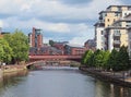 A view along the river aire in leeds with waterside apartments and buildings with crown point bridge crossing the water Royalty Free Stock Photo