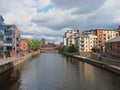 A view along the river aire in leeds with waterside apartments and buildings with crown point bridge in the distance