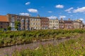 A view along the River Nene towards Georgian buildings on the North Brink in Wisbech, Cambridgeshire Royalty Free Stock Photo