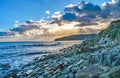 Sunray burst through the Swanage clouds at the rocky shore