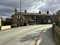 Hebden Bridge Road, with old stone cottages, and a cloudy sky in, Oxenhope, Yorkshire, UK