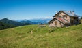 View of alpine mountain scenary with traditional old mountain chalet on a summer day. Dolomites mountains, South Tyrol, Italy