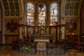 View of the altar and stained glass windows of a side chapel inside the Collegiale Notre Dame church in Dole Royalty Free Stock Photo