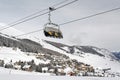 A view of an amazing beautiful village in the snow covered landscape and mountains and a cable car/lift in the alps switzerland in Royalty Free Stock Photo