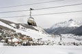 A view of an amazing beautiful village in the snow covered landscape and mountains and a cable car/lift in the alps switzerland in Royalty Free Stock Photo
