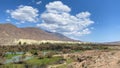 View of an amazing mountain valley. The stream runs through the trees in the park. Blue sky and white clouds. Beautiful summer Royalty Free Stock Photo