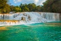 View of the amazing waterfall with turquoise pool surrounded by green trees. Agua Azul, Chiapas, Palenque, Mexico Royalty Free Stock Photo