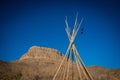 View of the american west with a saddle and a teepee