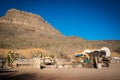 View of the american west with a saddle and a wagon Royalty Free Stock Photo