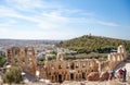 View of the ancient building Odeon of Herodes and the houses of the city of Athens, Greece.