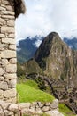 View of the ancient city of Machu Picchu, in the foreground the facade of an ancient house, Peru. Vertical orientation Royalty Free Stock Photo