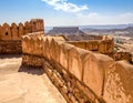 A view of an ancient fort with a few weathered walls overlooking the desert Royalty Free Stock Photo