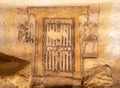 Ancient fresco representing a door decorating the wall of etruscan tomb in Italy