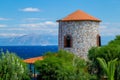 View of the Ancient Greek Windmill Tower and the Sea with Ship and Distant Coastline