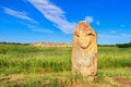 View of the ancient kurgan stela, stone idol against the backdrop of ancient mound of sandstone boulders