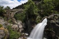 View of the ancient Mizarela Bridge or DevilÃ¢â¬â¢s Bridge with a waterfall, at the Peneda Geres National Park Royalty Free Stock Photo