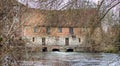 View of the ancient Old Mill at Harnham alongside the River Avon in Harnham, Salisbury, Wiltshire, UK Royalty Free Stock Photo