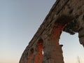 View of ancient roman acqueduct at sunset