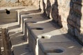 View of the ancient Roman ruins of Ephesus Anatolia, Turkey. Roman public toilet Royalty Free Stock Photo