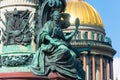 View of the ancient statues woman of stucco and the dome of St. Isaac`s Cathedral Petersburg.