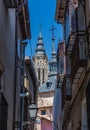 View from the ancient streets of the spire of the Toledo Cathedral and the Iglesia de Royalty Free Stock Photo