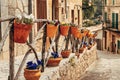 View of the ancient streets of Valldemossa. violets in clay pots on the hedge Royalty Free Stock Photo