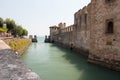 The view ancient walls and moat of Scaliger Castle, Sirmione, Lombardy, Italy Royalty Free Stock Photo