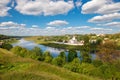 View on ancient white-stone Convent of the Dormition built in 16 century on Volga River bank with reflection in water. Staritsa, Royalty Free Stock Photo