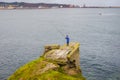 Angler fishing off the cliffs of Gijon Spain