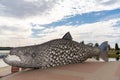 View of the anniversary celebration sculpture of a large metal salmon in the city center of Tornio