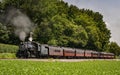 View of an Antique Restored Steam Passenger Train Blowing Smoke