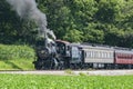 View of an Antique Restored Steam Passenger Train Blowing Smoke