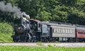 View of an Antique Restored Steam Passenger Train Blowing Smoke