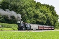 View of an Antique Restored Steam Passenger Train Blowing Smoke