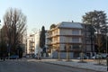 View of apartment buildings with cars on the road in the residential area of San Siro, in Milan, early in the morning