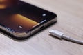 View of Apple Iphone 13 Pro Max with Lighting Cable Charger. EU try to Forced Apple