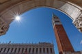 View from the arch of the Doge`s Palace Palazzo Ducale to the famous St. Mark`s Bell Tower Campanile di San Marco. Venice, Royalty Free Stock Photo