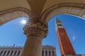 View from the arch of the Doge`s Palace Palazzo Ducale to the famous St. Mark`s Bell Tower Campanile di San Marco. Venice, Royalty Free Stock Photo