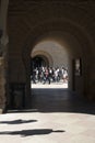 View through the arch on the group of young multinational people walking