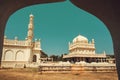 View from arch on tall minaret and historical Tipu Sultan Gumbaz in Srirangapatna, India. 18th century Muslim mausoleum Royalty Free Stock Photo