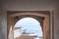 View from arch to Altea town white houses with tiled roofs and the Mediterranean sea at sunny day. Altea, Costa Blanca Royalty Free Stock Photo