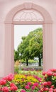 View through arched door, colorful flower bed spa garden bregenz