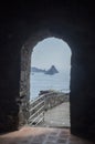 View from arched stone door in Norman castle Aci Castello to small rocky islands near Catania, Sicilia, Italy Royalty Free Stock Photo