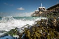 View on the architecture of the flood barrier `Neeltje jans` in the Netherlands from the rocky coast with seaweed and splashing Royalty Free Stock Photo